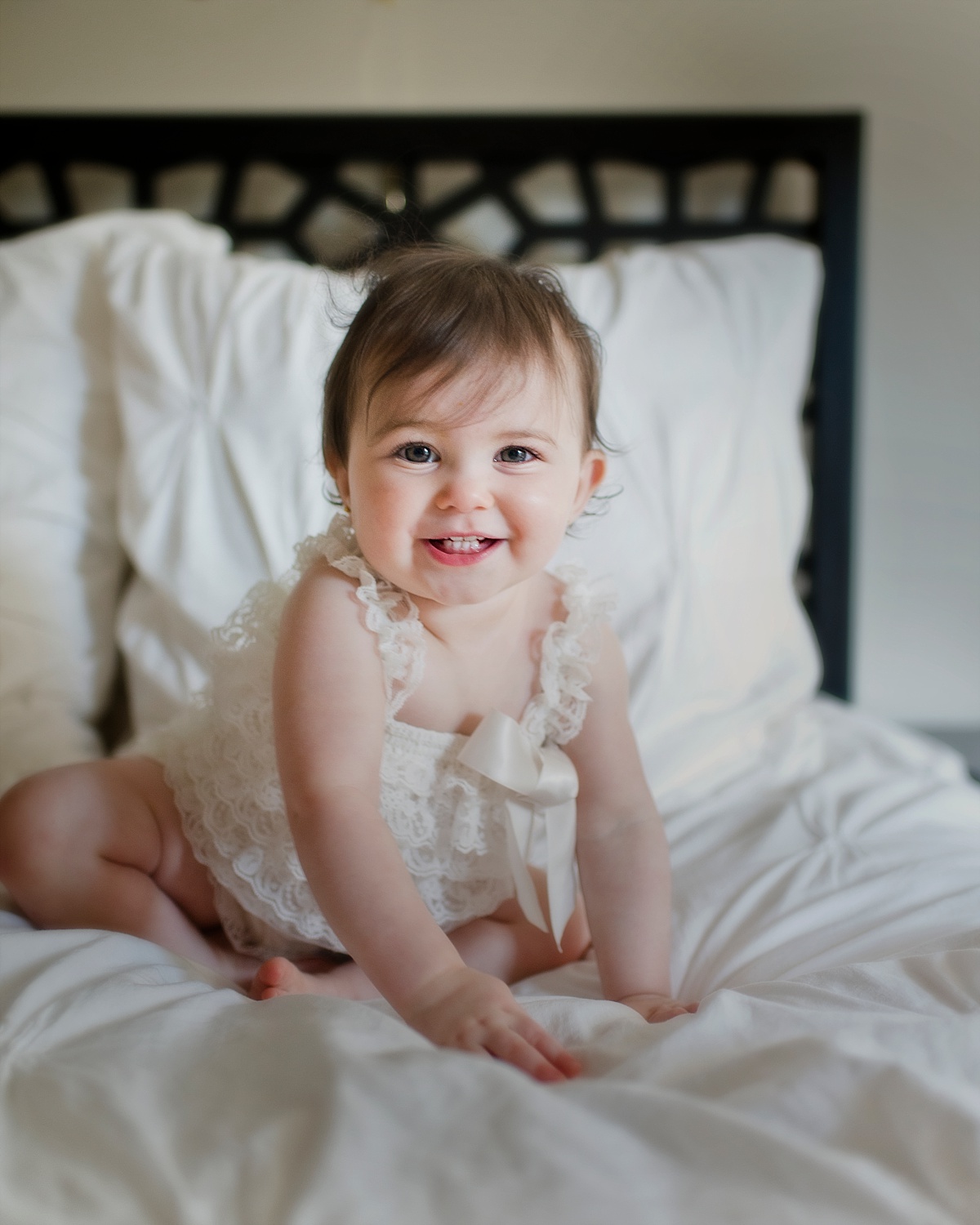 Indoor First Birthday Portraits in lace romper.
