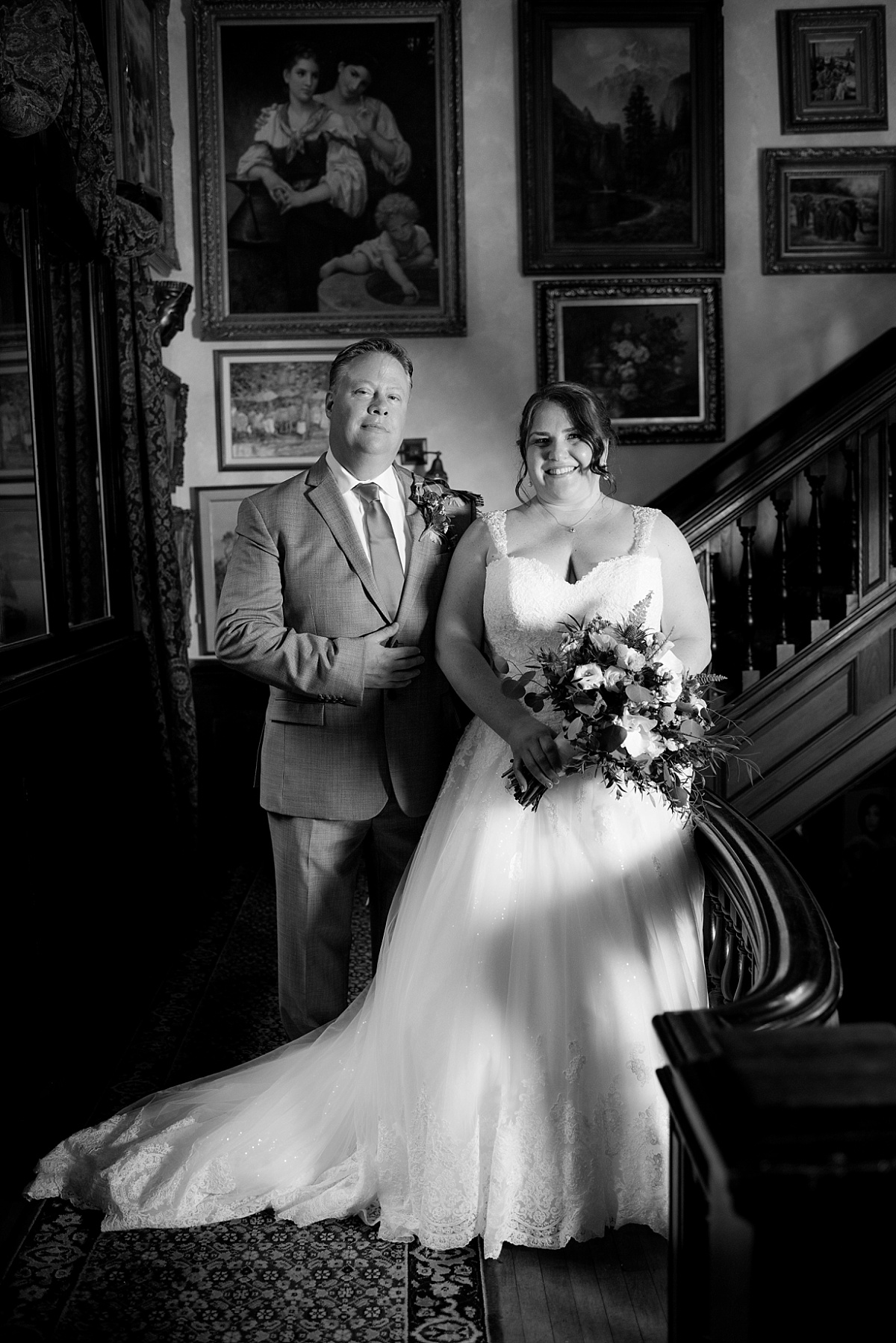 Black and White photo of bride and groom on the grand staircase at Gramercy Mansion Wedding